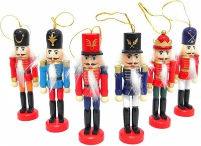 A group of six wooden nutcracker ornaments are displayed against a white background.
