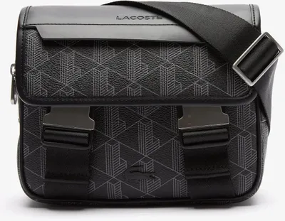 A studio shot of a black Lacoste messenger bag with a geometric pattern.