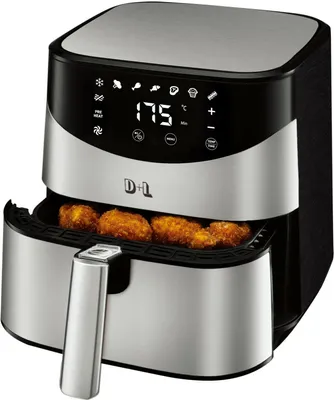 A close-up studio shot of a silver and black air fryer with food inside.
