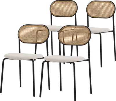 Four dining chairs with rattan backs and beige upholstered seats are arranged in a staggered formation against a white background.