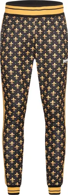 A pair of black track pants with a gold fleur-de-lis pattern and gold stripes on the sides.
