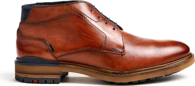A side view of a brown leather chukka boot with blue accents.