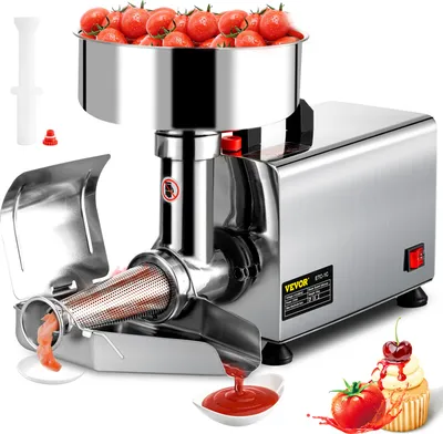 A stainless steel electric tomato press is shown with tomatoes in the hopper and tomato sauce being dispensed.
