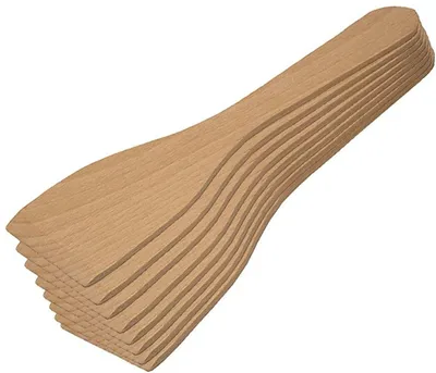 A stack of wooden spatulas on a white background.