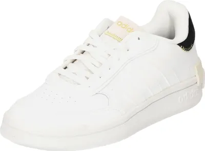 A white Adidas sneaker with gold and black accents.