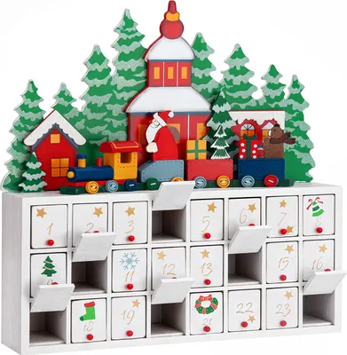 A wooden advent calendar shaped like a Christmas village with a train, trees, and Santa Claus.