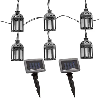A string of solar-powered lantern-shaped LED lights with two solar panels on stakes.