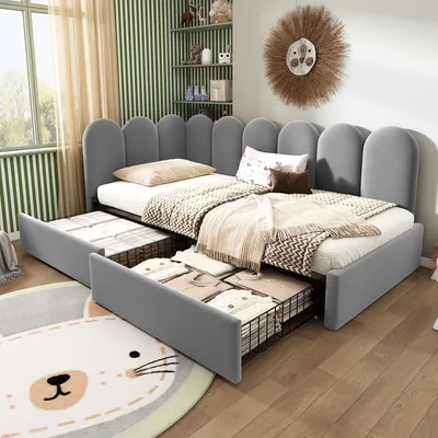 A child's bedroom with a grey upholstered corner bed with pull-out drawers, decorated with a lion head wall hanging and a cat-themed rug.