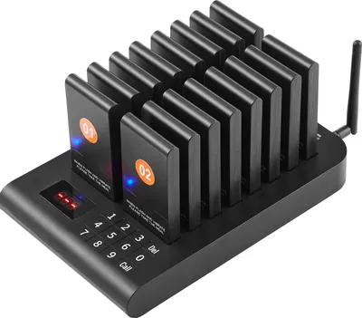 A black restaurant pager system with multiple pagers docked on a charging base.