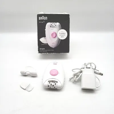 A Braun Silk Epil 1 epilator and its accessories are displayed on a white background, along with its packaging.