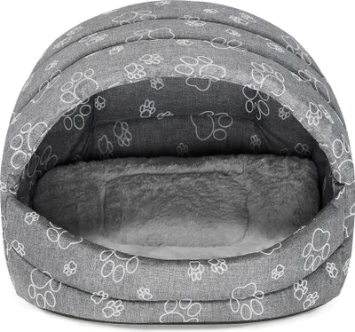 A gray dog bed with paw print patterns.