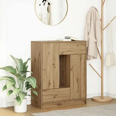 A wooden sideboard with drawers and doors, placed in a room with a plant and a coat rack.
