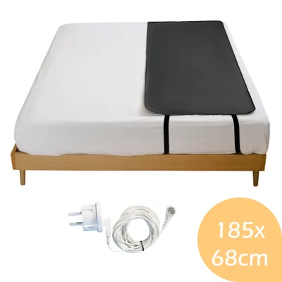 A heated mattress pad and its accessories on a bed.