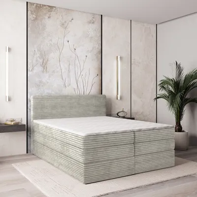 A bedroom scene with a bed and wall art.