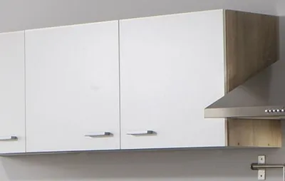 A close-up of a kitchen cabinet and a range hood.