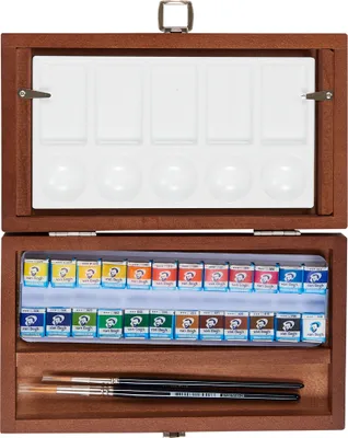 An open wooden box containing watercolor paints and brushes.
