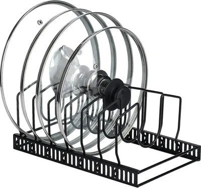 A black metal rack holding several glass pot lids.