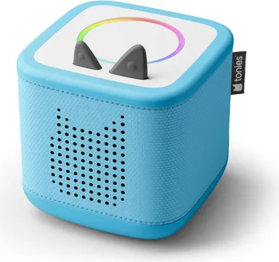 A blue Tonies Toniebox with cat ears and a rainbow light ring on top, shown from a slightly elevated front-left angle on a white background.