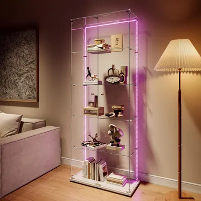 A modern living room with a glass display cabinet filled with decorative items, illuminated by pink LED lights.