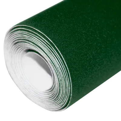 A roll of green velour fabric is shown from a close-up, angled view.