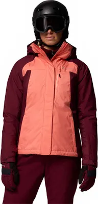 A woman wearing a ski jacket and pants, helmet and goggles.