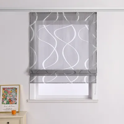 A window with a gray Roman blind featuring a white wavy pattern, set against a light gray wall.