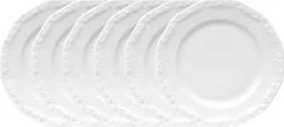 A set of white plates with decorative edges.