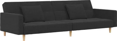 A dark gray fabric sofa bed with two pillows and wooden legs, shown from the front.