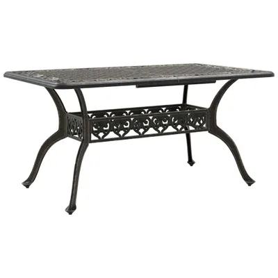 A rectangular outdoor dining table with ornate detailing on the legs and a lower shelf.