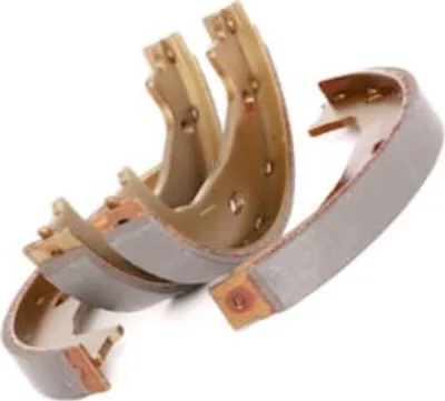Several brake shoes are arranged in a pile against a white background.