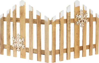 A wooden fence decoration with white tips and snowflake ornaments.