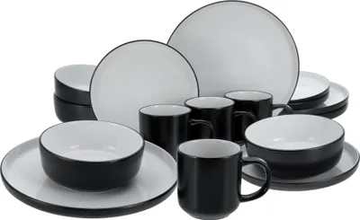 A set of black and white stoneware dishes and mugs are arranged on a white background.