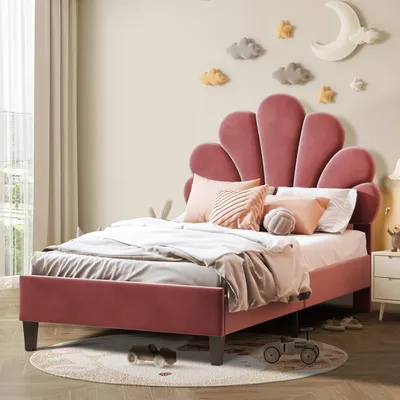 A child's bedroom with a pink velvet bed and decorative wall elements.