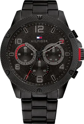 A close-up studio shot of a black Tommy Hilfiger men's chronograph watch.