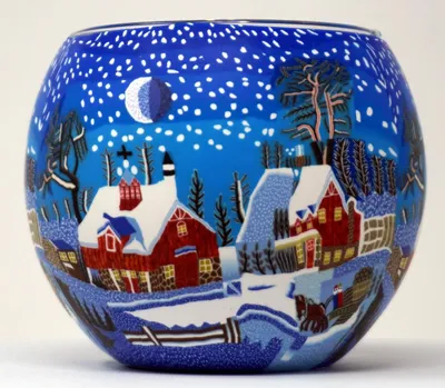 A glass lantern with a winter scene painted on it.