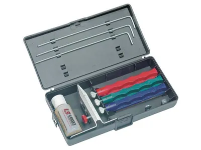 An open sharpening kit with various sharpening stones and rods.