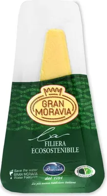 A wedge of Gran Moravia cheese in vacuum-sealed packaging.