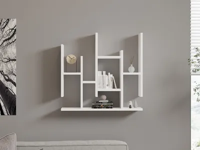 A white geometric shelf unit mounted on a gray wall, decorated with books, a clock, and a vase.