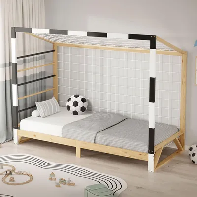 A child's bed designed to look like a soccer goal, set up in a bedroom.