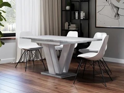 A dining room with a table and chairs.