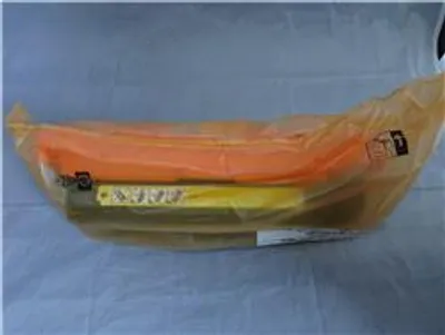 A product wrapped in plastic packaging, lying on a light gray surface.
