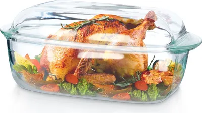A roasted chicken with vegetables in a glass baking dish with a glass lid.