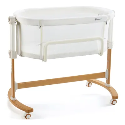 A white and wood baby bassinet on a white background.