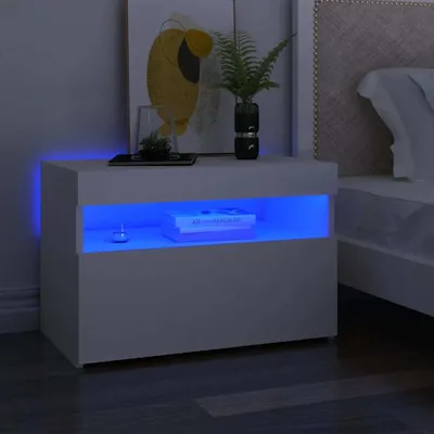 A white nightstand with blue LED lighting is shown next to a bed.