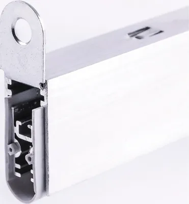 A close-up, angled view of a metal and white door bottom seal.