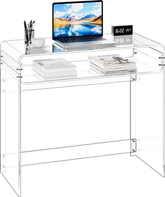 A clear acrylic desk with a laptop, a cup, and books on it, set against a white background.