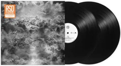 A vinyl record album cover and two vinyl records.
