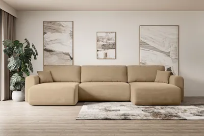 A modern living room with a large beige sectional sofa, abstract art on the wall, and a potted plant.