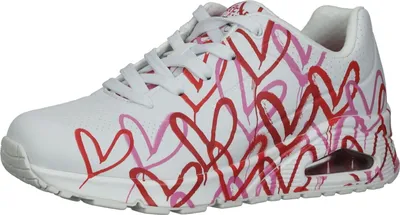 A white sneaker with a red and pink heart pattern.