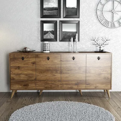 A wooden sideboard with drawers and doors, decorated with framed pictures and a clock on the wall, and a rug on the floor.